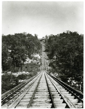 View of tracks going up a hill to a building of the Thurmond Coal Company.