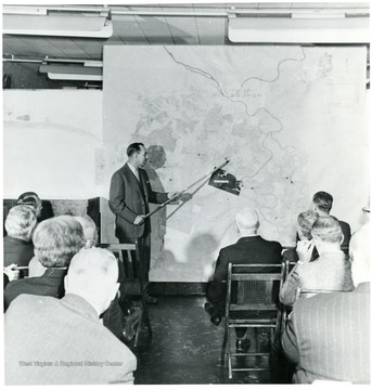 Coal official pointing at a map of Pittsburgh during a Consolidation Coal Co. Inspection trip.