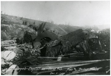 crowd of people looking at the destroyed fan and boiler house after Monongah Mine explosion. 