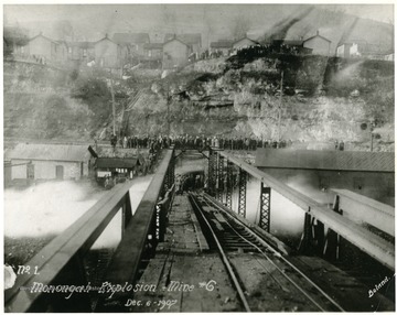 Crowds gather above and at the end of the trestle leading into mine no. 6 after the explosion.