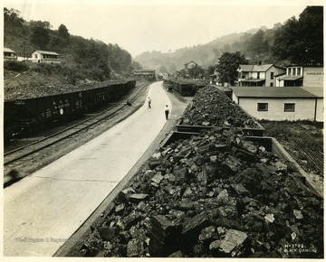 Houses along the tracks with loaded coal cars at Pursglove, W. Va. 