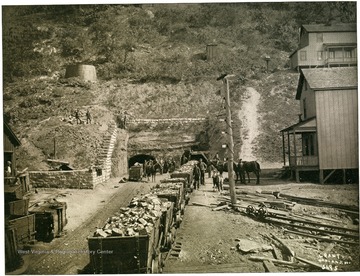 Coal carts leaving a mine entrance.  