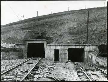 Tracks lead into the entrance and exit of a coal mine