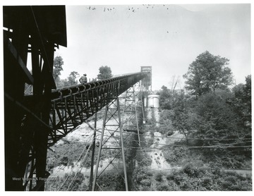 Jamison No. 9 Mine refuse belt on stilts with a man walking the length of it.