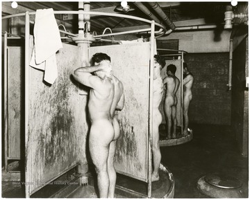 Men taking showers in a bath house at Monongah Central Shop.
