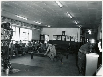 Group of miners sitting on benches relaxing.