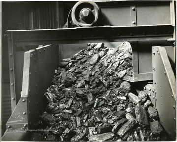 Pile of coal at the end of a conveyor.