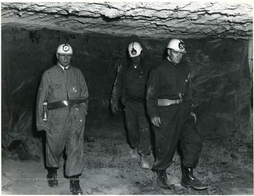 Donald Ammons, Center, Safety Inspector, Christopher Coal Co., conducts Dr. Miles  J. Martin, Left, Chief, Office of Mineral Information, Washington, D.C., and John D. Spencer, Morgantown Coal Research Center, on tour of Christopher Coal Co. Mine No. 15, at Cassville, W. Va. 'U.S. Bureau of Mines Photo Proof Print. Not for publication, permanent record, or other use outside of the Morgantown Research Center. 