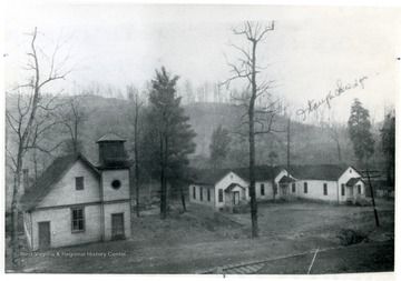 On the right is the MacDonald Presbyterian Church, and on the left is probably a schoolhouse.