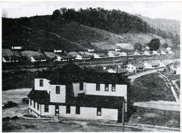 Section of town of Whipple, West of the company store showing store in the foreground, miner's homes in the distance.
