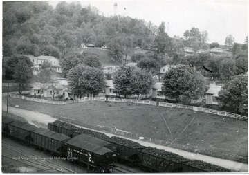 Trains filled with coal file past a group of miners houses in Sprague, W. Va.