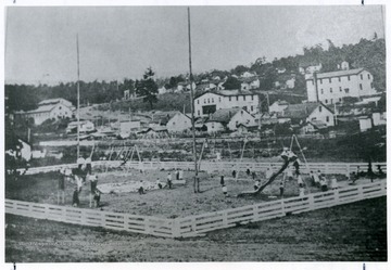 Children playing at the Cranberry playground, with a view of the town in the background.