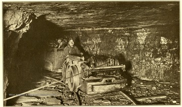Man in tram car in mine in the Winifrede Coal Seam, Kanawha County, W. Va. 'Geological Survey.'