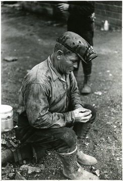 Unknown miner sitting down outside of the mine. 'Please credit Farm Security Administration for Photo.