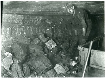 'Coarse Lumpy Coal: This very coarse lumpy mine run coal is the result of proper shooting. The miner is paid on a tonnage basis for loading this coal into mine cars. He is required to watch his coal carefully as he loads it and she that no impurities become mixed with the coal.'