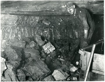 'This very coarse lumpy mine run coal is the result of proper shooting. The miner is paid on a tonnage basis for loading this coal into mine cars. He is required to watch his coal carefully as he loads it and see that no impurities become mixed with the coal.'