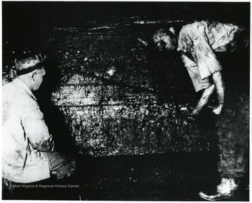 Two miners at work drilling into a wall of coal. John Williams, Coal Life Project.