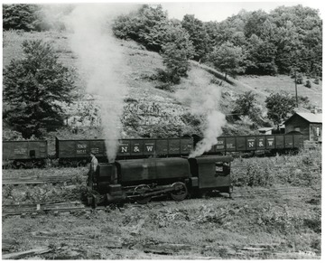 'A steam haulage locomotive of the type used in Buckeye No. 1 Mine of Buckeye Coal and Coke Company, Pocahontas District, for over fifty-one years. Permission is granted to reproduce this photograph only on the condition that each reproduction shall bear the following credit line: Photograph by Norfolk and Western Railway.'