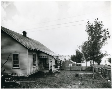 Row of houses with a few kids present in the yards.