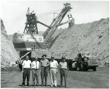 Group of men stand near Hanna Coal Co.'s shovel 'The Mountaineer' as well as a Euclid coal truck.
