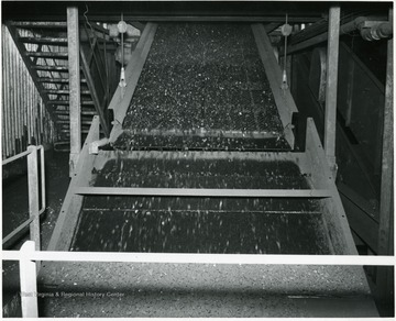 Coal traveling down a conveyor for processing.