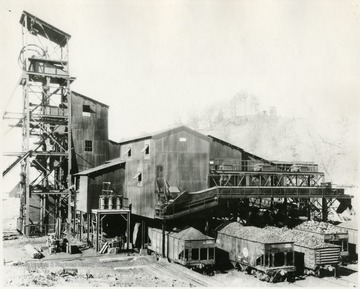 Railroad cars filled with coal outside the plant buildings.