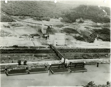 Aerial view of the plant, railroad cars, and docks.