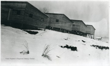Four barracks on a snowy hill in Viropa, W. Va.