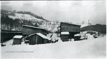 Three barracks in the snow.
