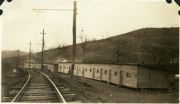 Barracks beside railroad tracks.