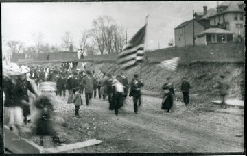 Unidentified group of miners and their families marching in a parade. 