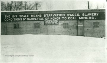 Sign on side of building reads, 'The 1917 scale means starvation wages, slavery conditions [and] sacrafice of honor to coal miners.'