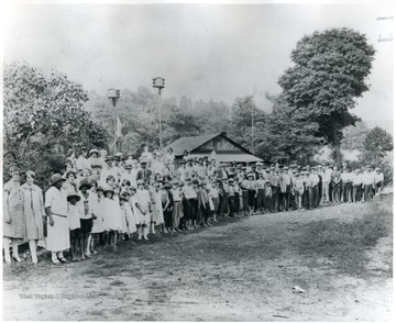 Many men, women, and children standing on a picket line at Local No. 1643 in Monongah, W. Va.