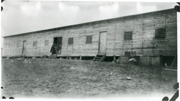 Two people in doorway of barracks at Rivesville, W. Va.