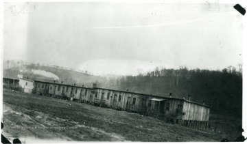 Barracks at Maidsville, W. Va. with smoke rising from one chimney.