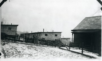 Barracks and house with snowy ground at Monongah, W. Va.