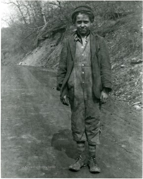 Eugene Collings standing on a dirt road.