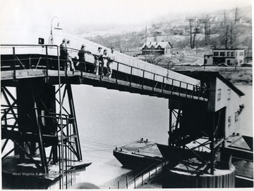 Loading barges for shipment on the Monongalia River. 'For information on the Mountaineer Mining Mission See A&M 2491 (SC).'