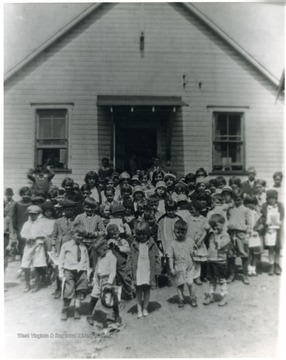 Group portrait of children outside of schoolhouse. 'For information on the Mountaineer Mining Mission See A&amp;M 2491 (S.C.).'