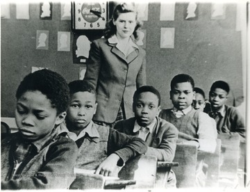School children of the Osage School in the 1940s and their teacher. For information of the Mountaineer Mining Mission, see A&M 2491 (SC).L to R: Tommy Wells (deceased), Sammy Dobbs (lived in Jerome Park for ling time, shot to death), Wesley Morton, Jimmy Summervile, unidentified, "Snookie" Williams.Teacher most likely someone who came for a special mission, possibly Mountaineer Mining Mission.