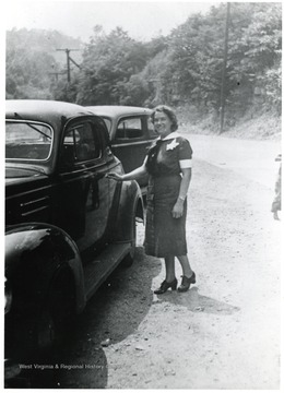 View of Nurse Marie Isselstein entering a car.