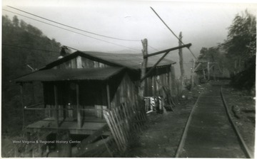 'Billy Wells and Shorty.' Buildings on top of mountain at Fire Creek.