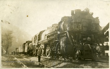 Man standing next to a freight train.