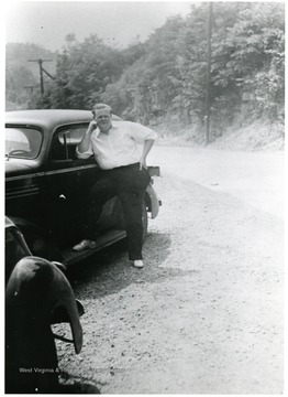 Alton Mackay standing next to a car.