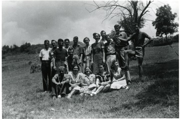 Group portrait of friends in a field.  Possibly American Friends Service Committee workers.