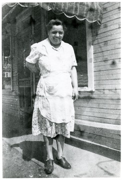 Sylvia Viola standing outside of house.