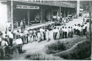 People line the streets in front of the Matewan Hardware and Furniture Co. Inc. on Union Relief Day. 'Pix used on page 58 of book.'