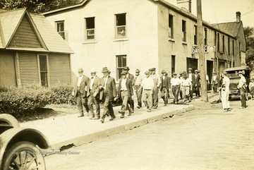 Men being escorted to a train to go to a jail in Wheeling, W. Va. 'Wed. 9 a.m.'
