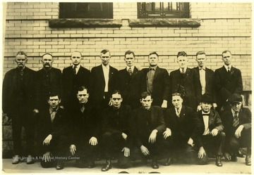 'Left to Right 'Standing': Jim Maggard, Jury Foreman, Reese Chambers, C.H. Kisser, Fred Burgraph, Sid Hatfield, Nat Attwood, Ed Chambers, Lee Toller, and Clare Overstreet. Left to Right 'Kneeling': Bouser Coleman, Ben Mounts, Bill Bowman, Van Clay, Art Williams, and Hallie Chambers.  First Row third from right is Jess Boyd, his name was not on the list. Pix used on page 61 of [Lee's] book.'