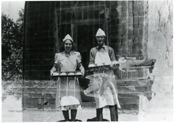 Two bakers stop for a picture.  Possibly American Friends Service Committee members.